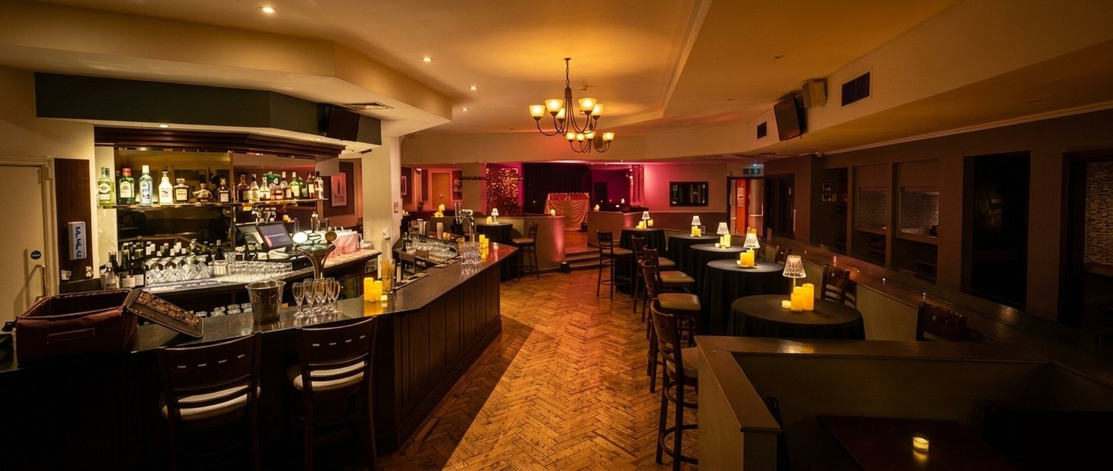 Steam Wine Bar interior, the full venue set for an evening, bar to stage, candlelit and atmospheric