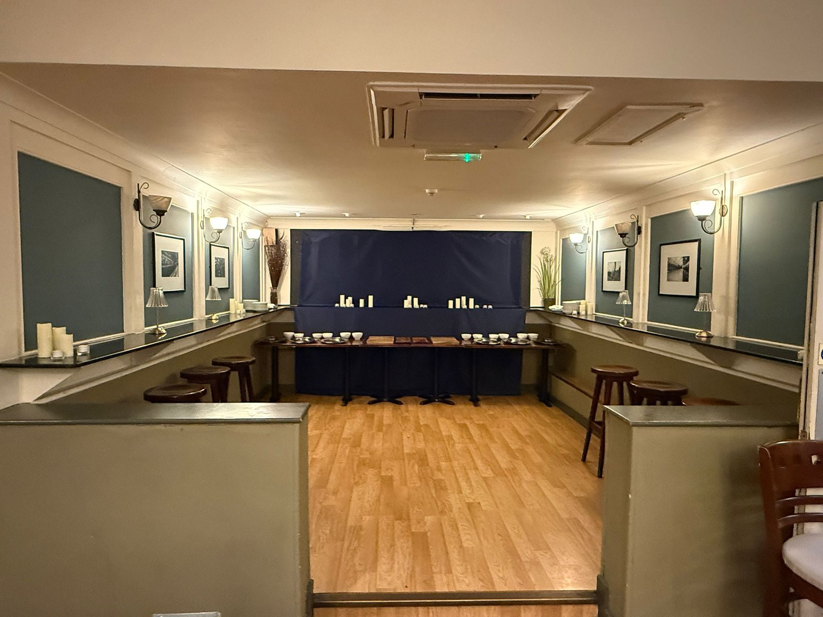 Steam Wine Bar, a U-shaped table arrangement with wall lighting, set for a corporate dinner